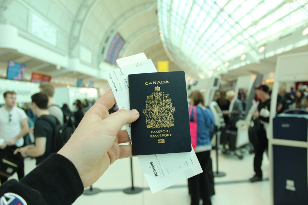 Canadian passport and plane ticket in hand