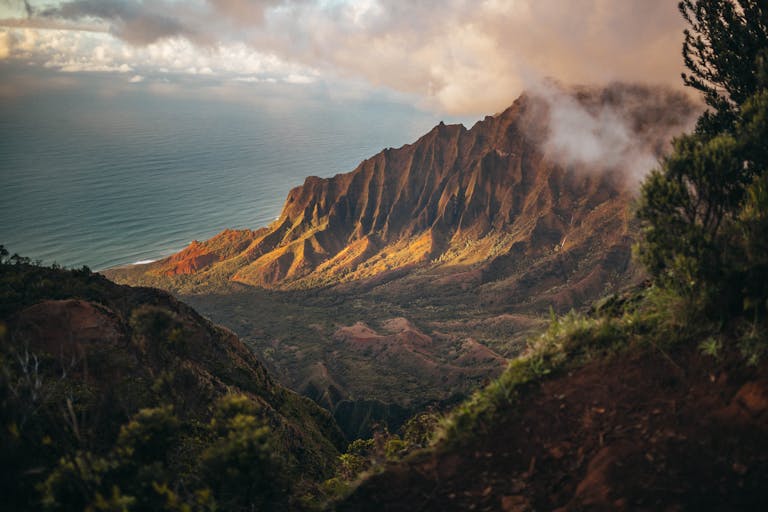 A stunning view of the Kalalau Valley with mountains and ocean in Kauai, Hawaii.