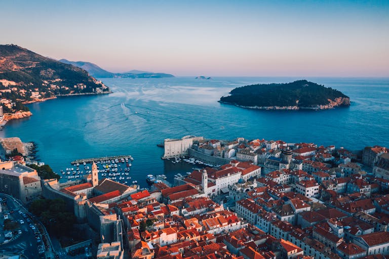 Breathtaking sunset over Dubrovnik's historic cityscape and Adriatic coast.