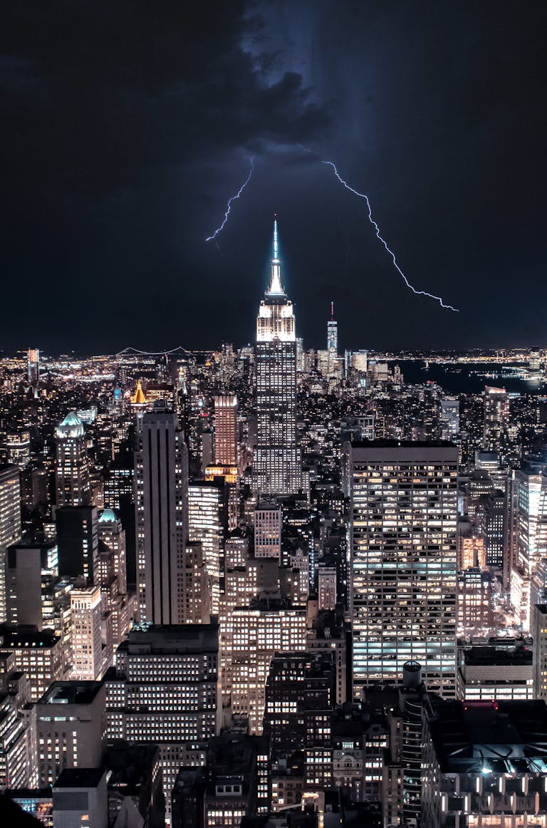 Dramatic view of NY skyline with lightning striking the Empire State Building.