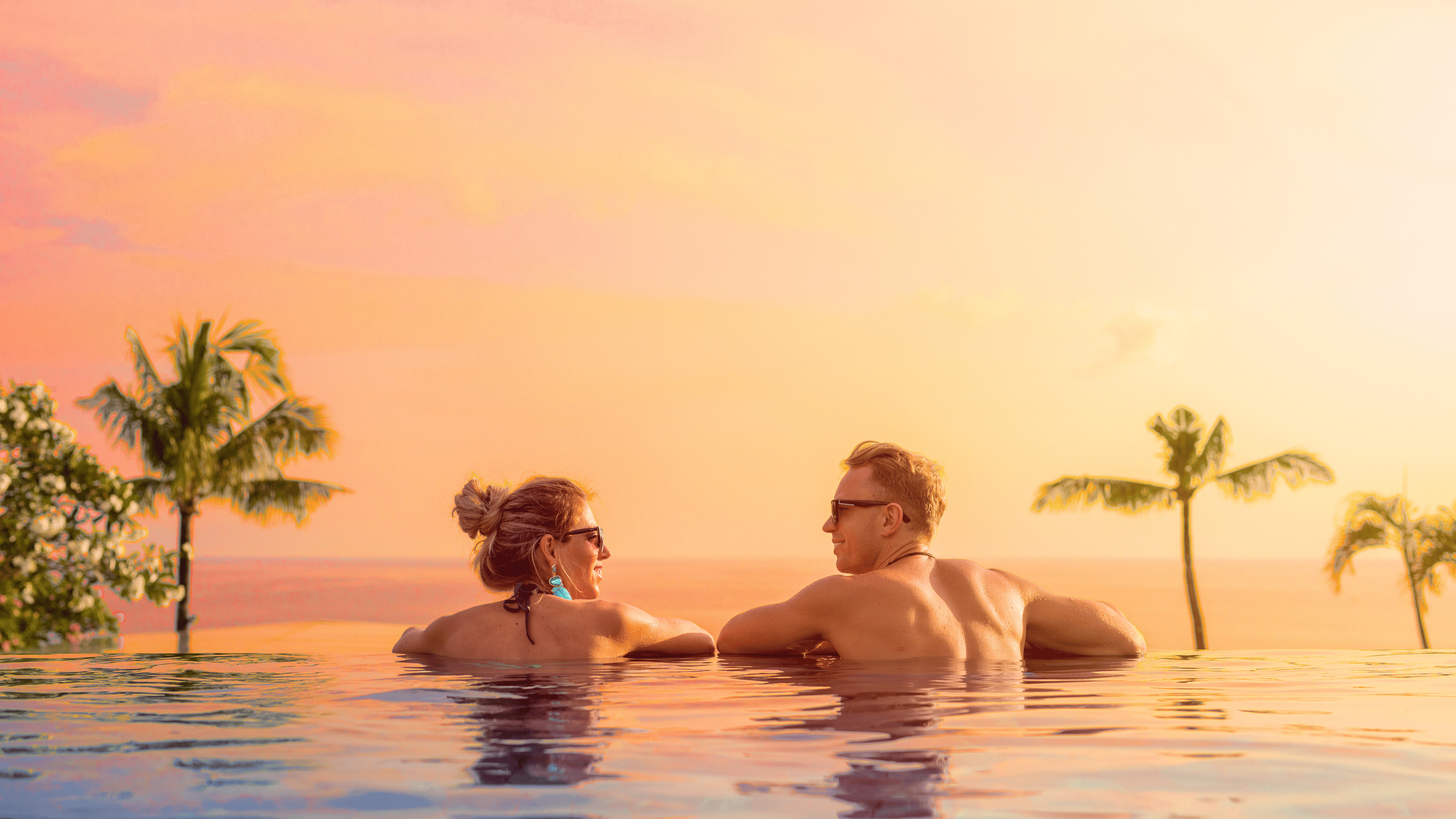 Couple Sunset male female in pool tropical all inclusive