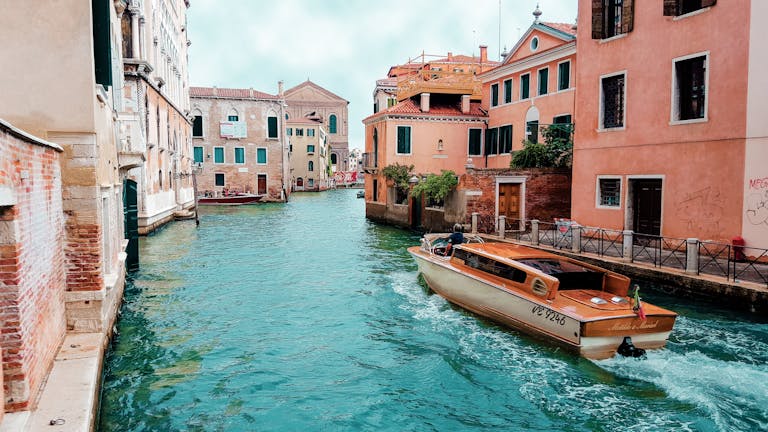 Picturesque view of Venice's canals with charming architecture and traditional boat.