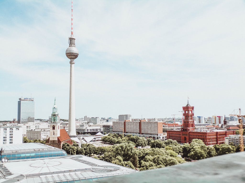 A breathtaking daytime aerial shot of Berlin featuring the Fernsehturm and vibrant architecture.