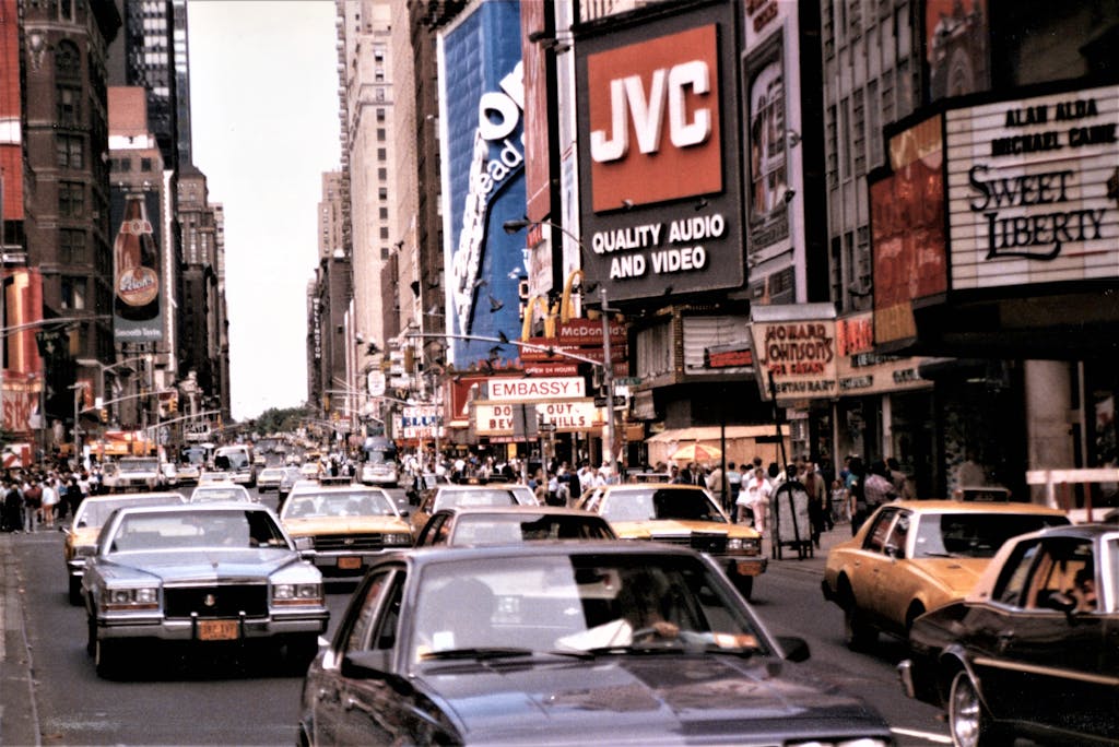 A bustling scene of vintage cars and iconic billboards in Times Square.