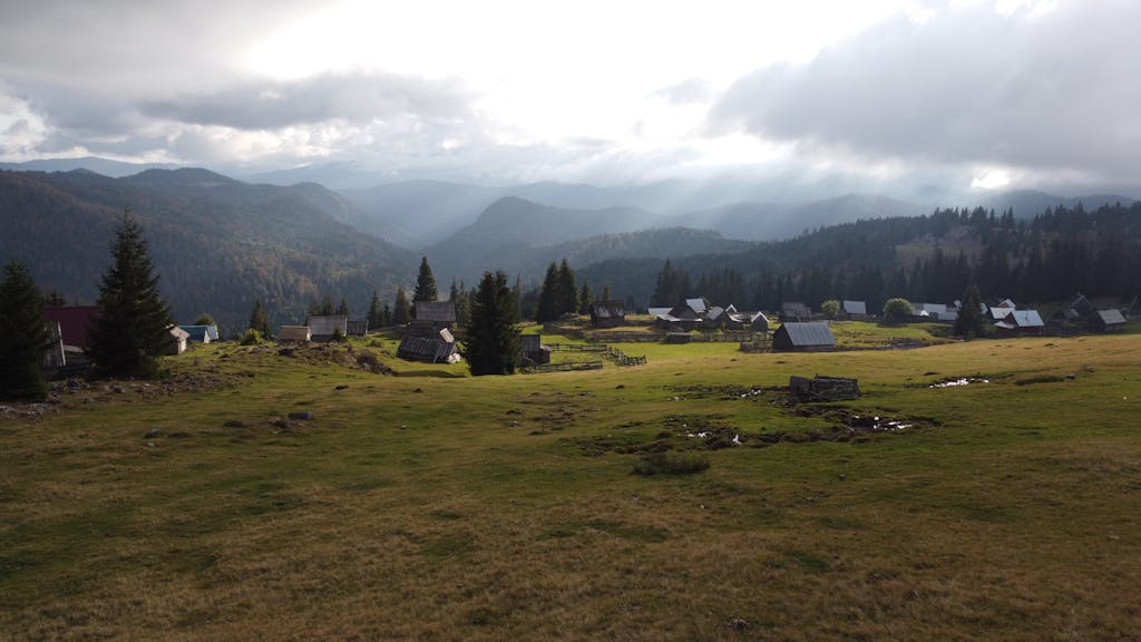 Aerial view of a picturesque rural village nestled in the Romanian mountains.