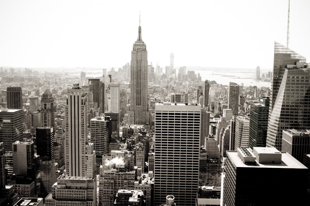 Aerial view of Manhattan's iconic skyline featuring the Empire State Building in monochrome.