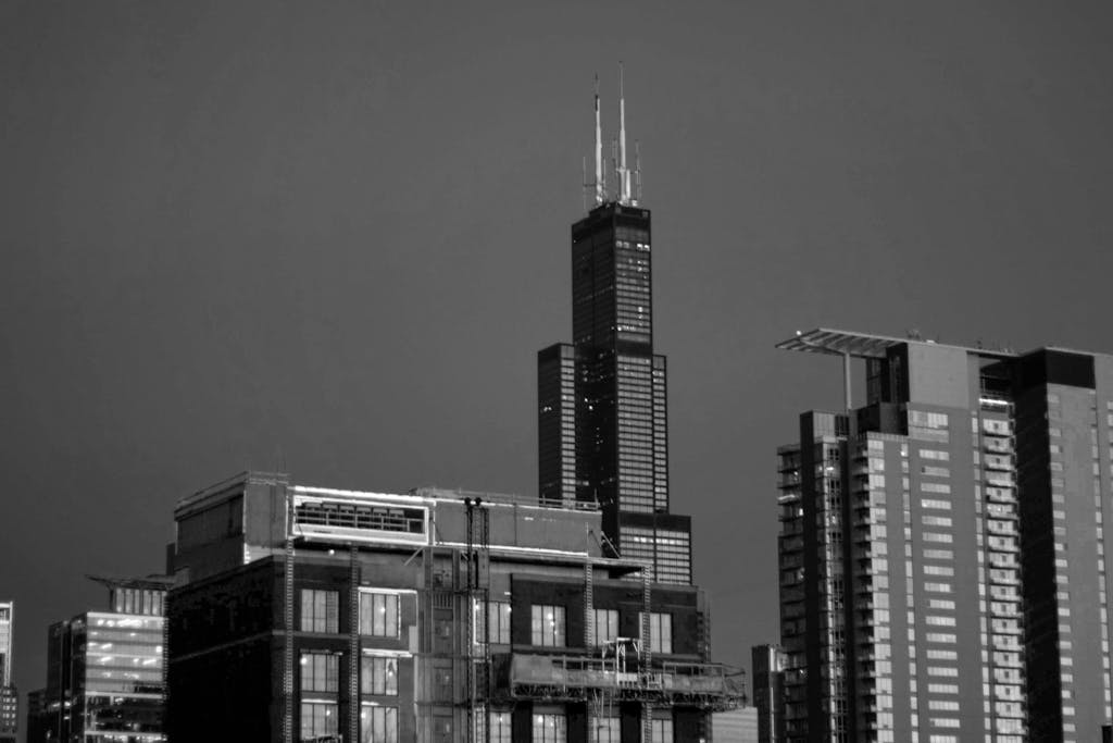 Black and white photo of Willis Tower and Chicago skyline showcasing urban architecture.