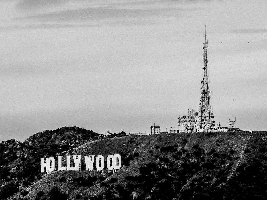 Black and white view of the Hollywood Sign and communication tower in Los Angeles.