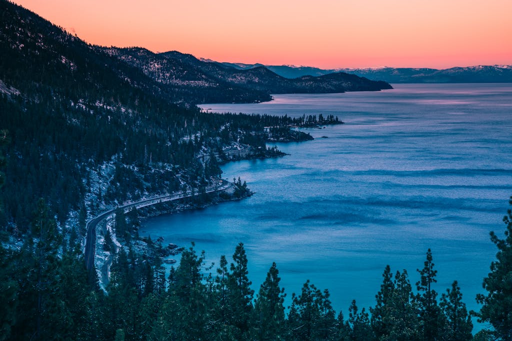 Breathtaking sunset view of Lake Tahoe's serene blue waters and surrounding mountains.