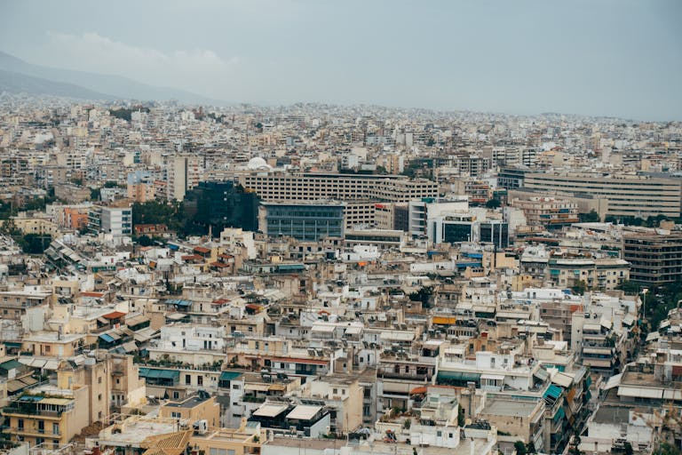 Expansive aerial view capturing the dense cityscape of Athens, Greece.