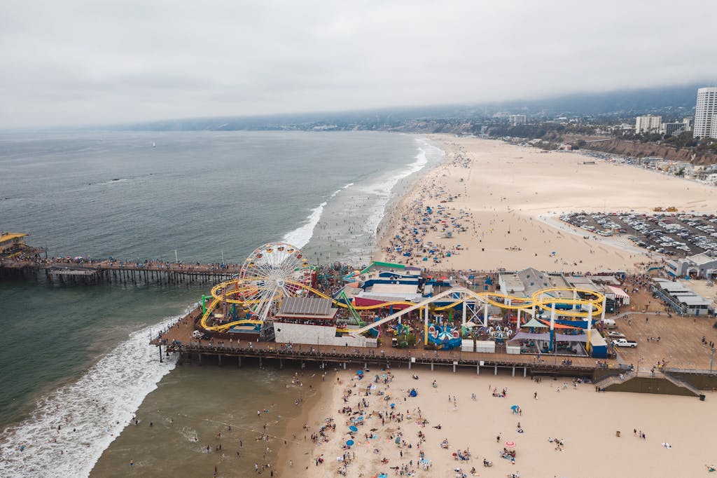 Explore the vibrant Santa Monica Pier and beach with this stunning aerial view of Los Angeles' iconic coastline.