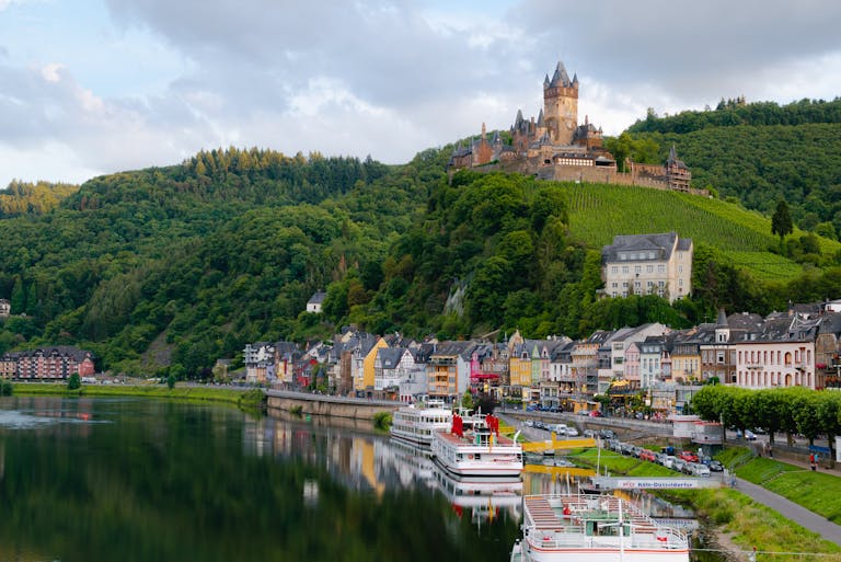 Idyllic landscape of Cochem Castle overlooking Moselle River in Germany.