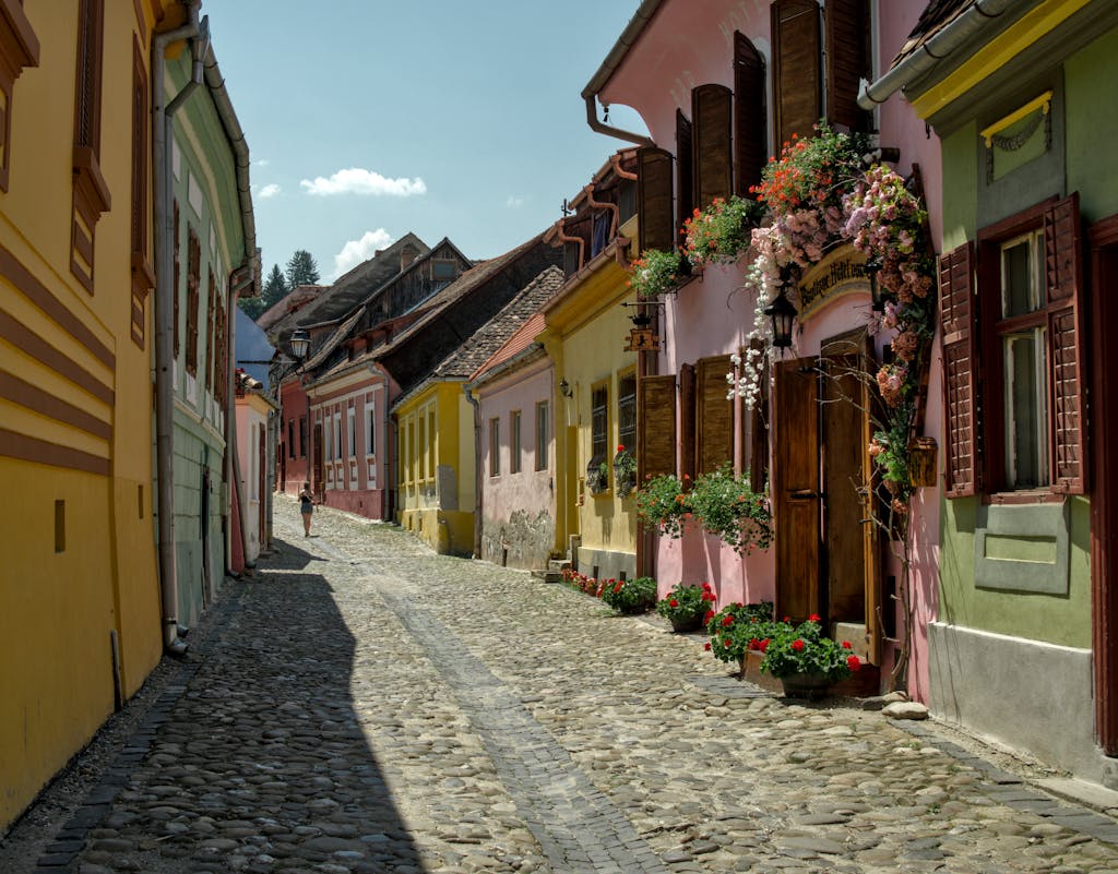 Picturesque old street with colorful medieval buildings in Sighișoara, Romania.