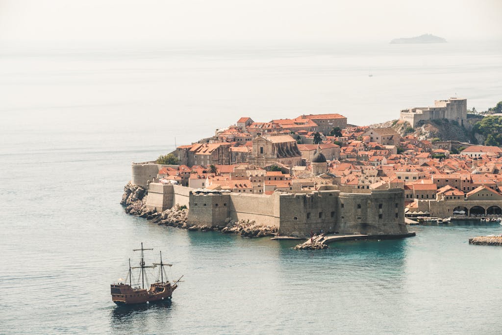 Stunning aerial photo of Dubrovnik's old town and city walls by the Adriatic Sea.