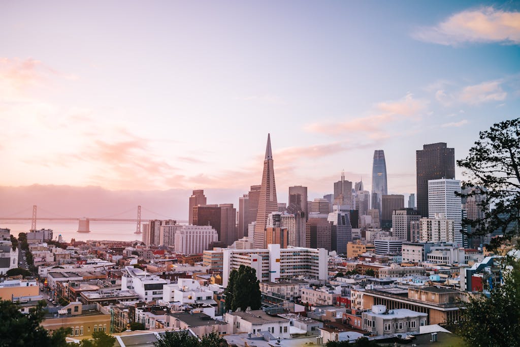 Stunning view of San Francisco cityscape with iconic landmarks during sunrise.