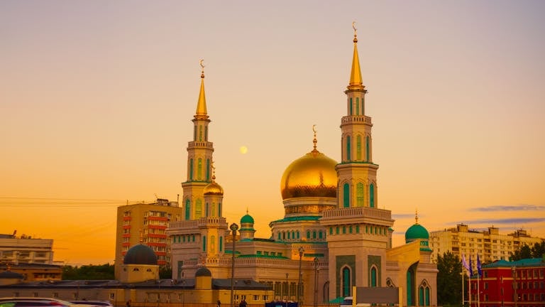 Stunning view of the Moscow Cathedral Mosque during sunset with a golden dome and minarets.