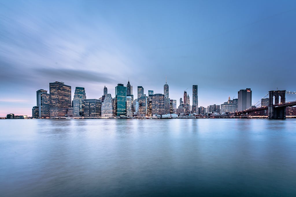 Stunning view of the New York City skyline and Brooklyn Bridge at dusk.