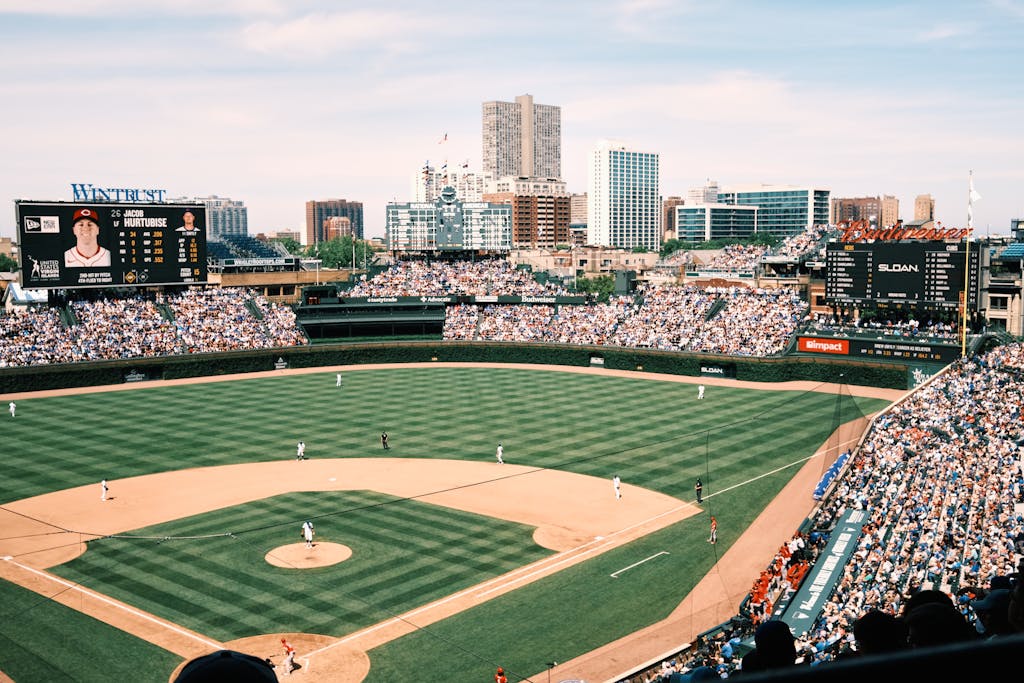 Wide-angle shot of Wrigley Field filled with spectators during a baseball game in Chicago.