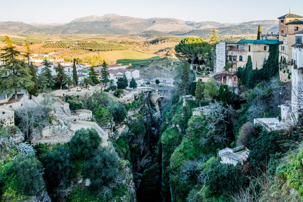 A breathtaking aerial view of the dramatic landscape and historic buildings of Ronda, Spain.