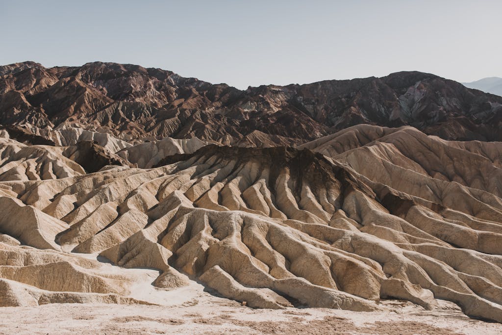 A dramatic view of eroded desert rock formations under a clear sky.