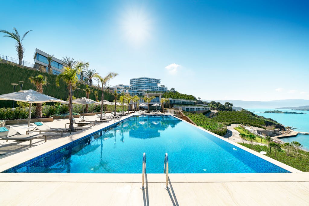 A luxurious seaside resort in Bodrum, Turkey, featuring a stunning infinity pool under sunny skies.