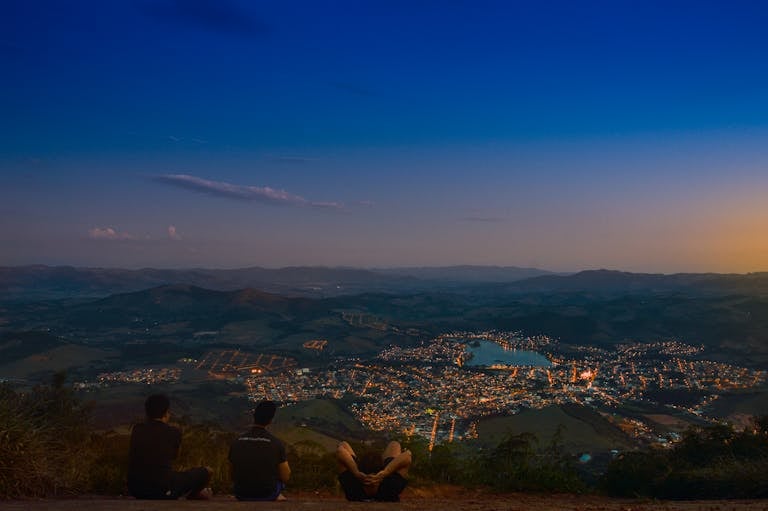 A peaceful evening overlooking Lambari, Brazil with city lights and a serene landscape.