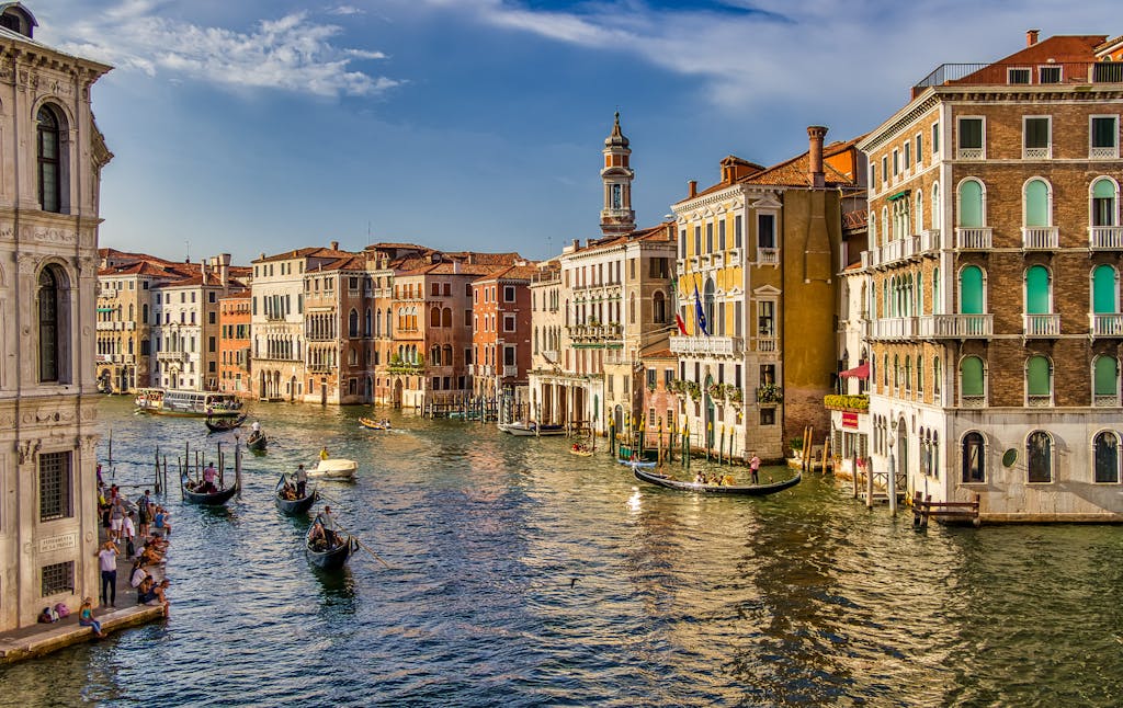 A picturesque view of gondolas on the Grand Canal in Venice, Italy with historic architecture.