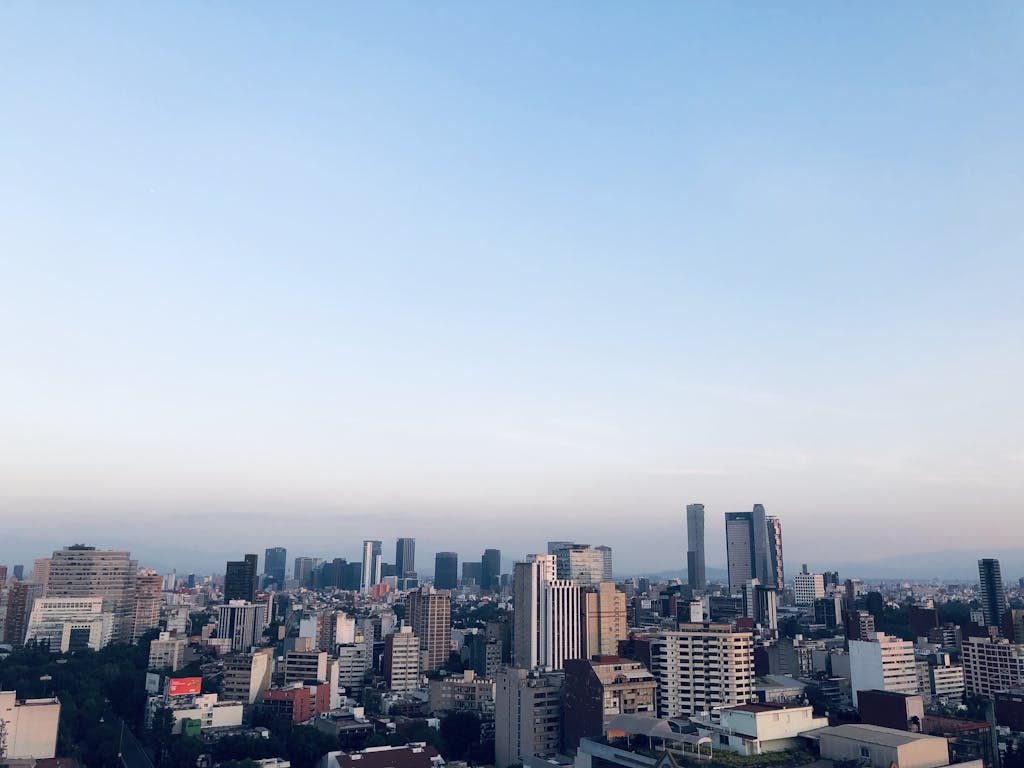 Beautiful aerial view of Mexico City's skyline with skyscrapers under a clear blue sky.