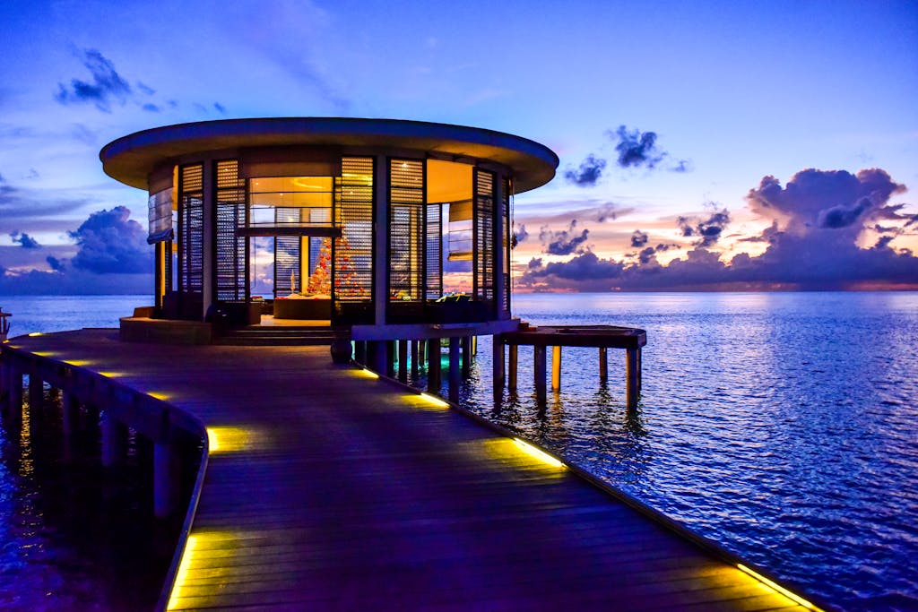 Beautiful round pavilion on a pier overlooking the tranquil sea at sunset.