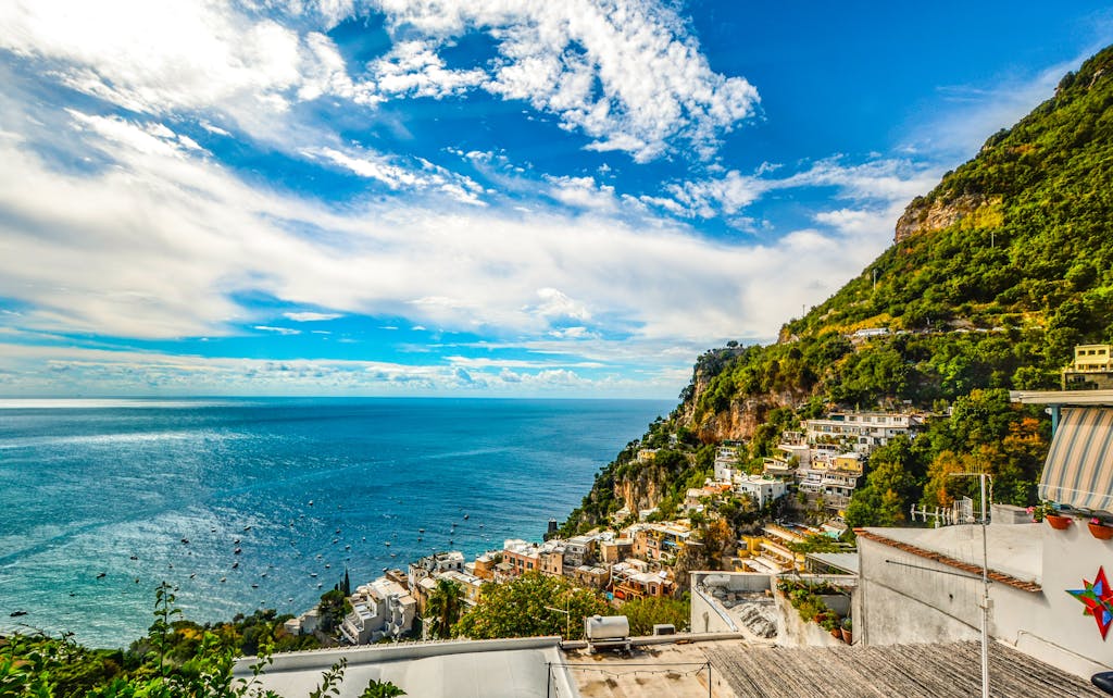 Breathtaking view of the Amalfi Coast with vibrant blue sea and lush green hillsides.