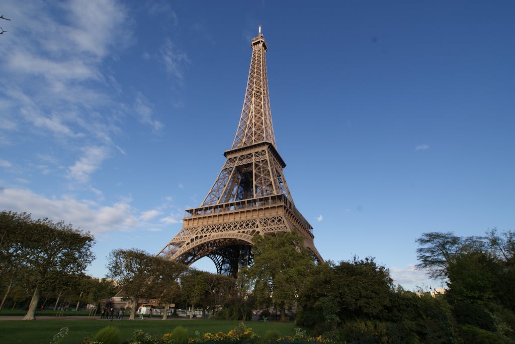 Captivating photo of the Eiffel Tower in Paris, showcasing its grandeur against a clear blue sky.