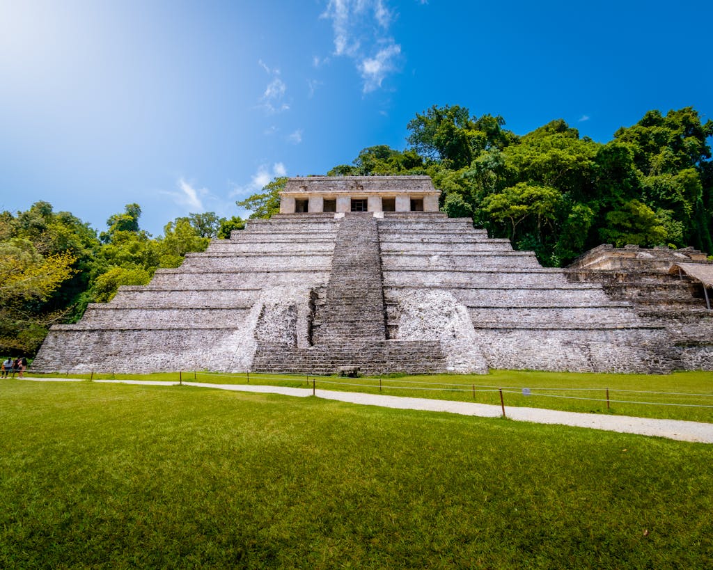 Capture of the iconic Pyramid of the Inscriptions in Palenque, Mexico under clear blue sky.