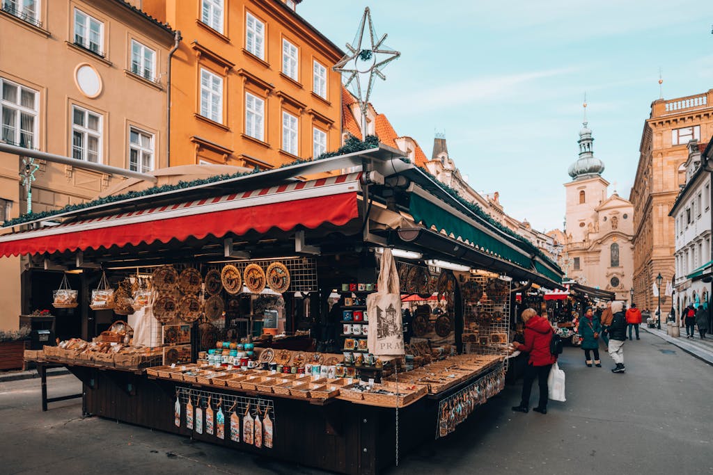 Colorful outdoor market stall in European city with souvenirs and bustling street life, perfect for tourism imagery.