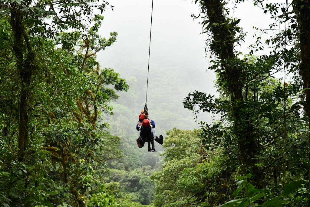 Experience an exhilarating zip line ride through the lush Costa Rican rainforest, ideal for adventure seekers.