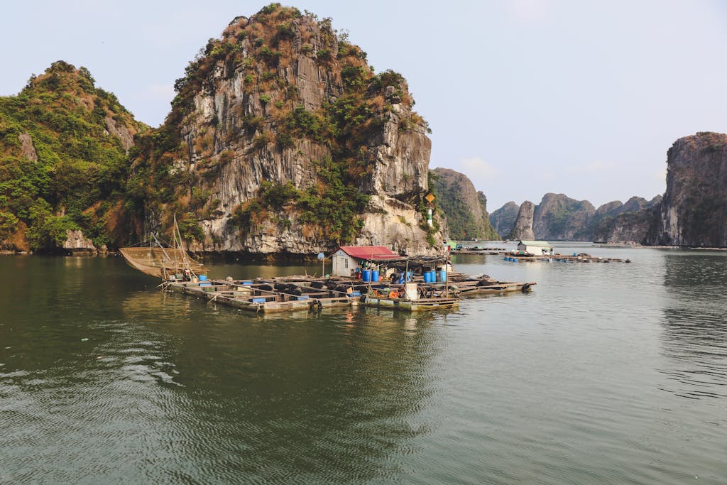 Experience the serene fishing life amid stunning rock formations in Ha Long Bay, Vietnam.