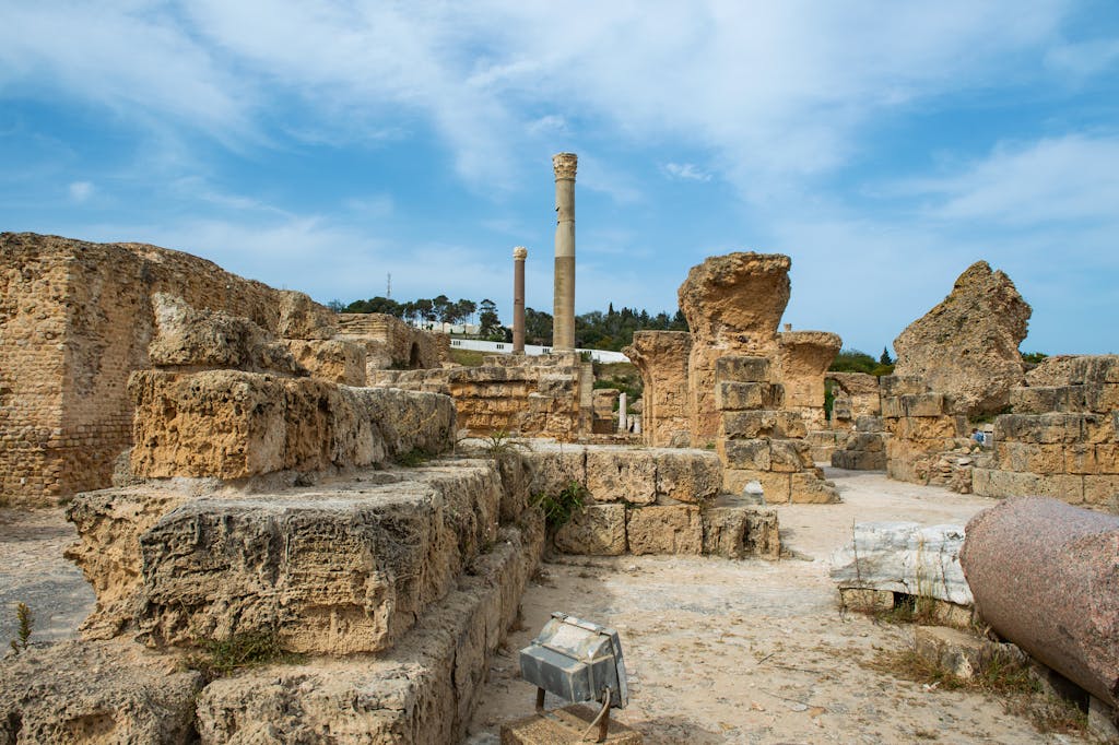 Explore the ancient ruins of Carthage, capturing historic structures and weathered stones under a bright sky.