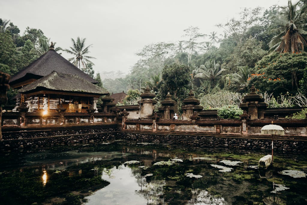 Explore the tranquil beauty of a Balinese water temple amidst lush greenery. Perfect for travel inspiration.