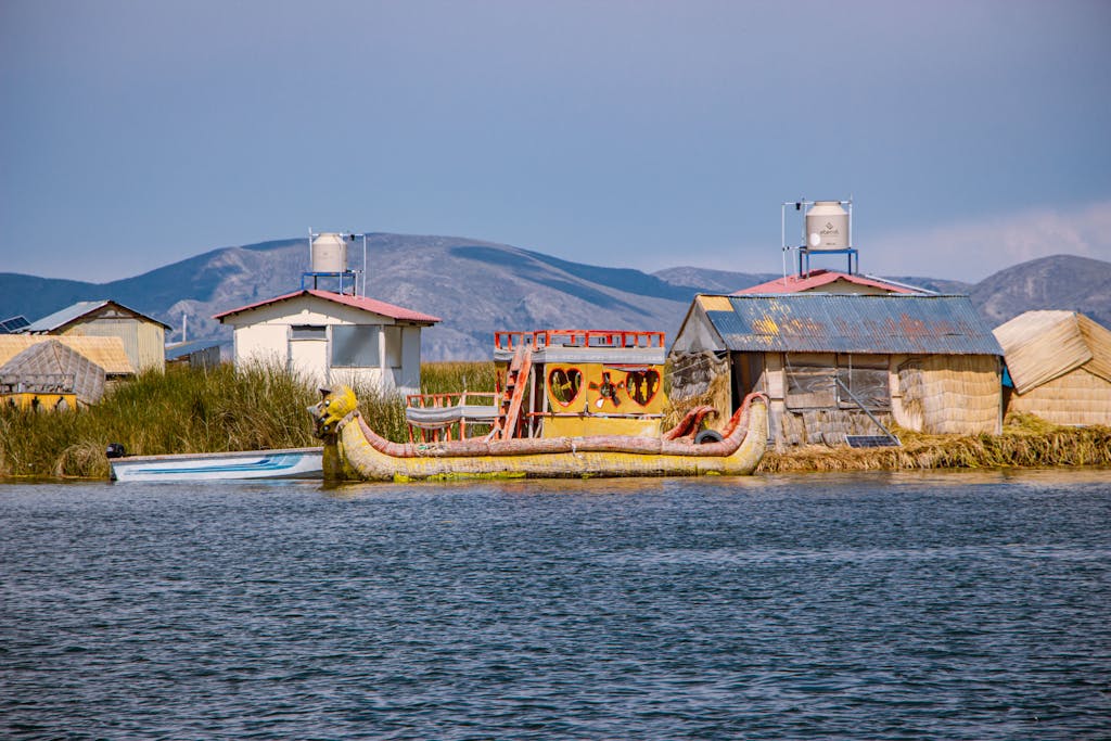 Explore the unique floating villages on Lake Titicaca in Puno, Peru, showcasing traditional reed houses and boats.