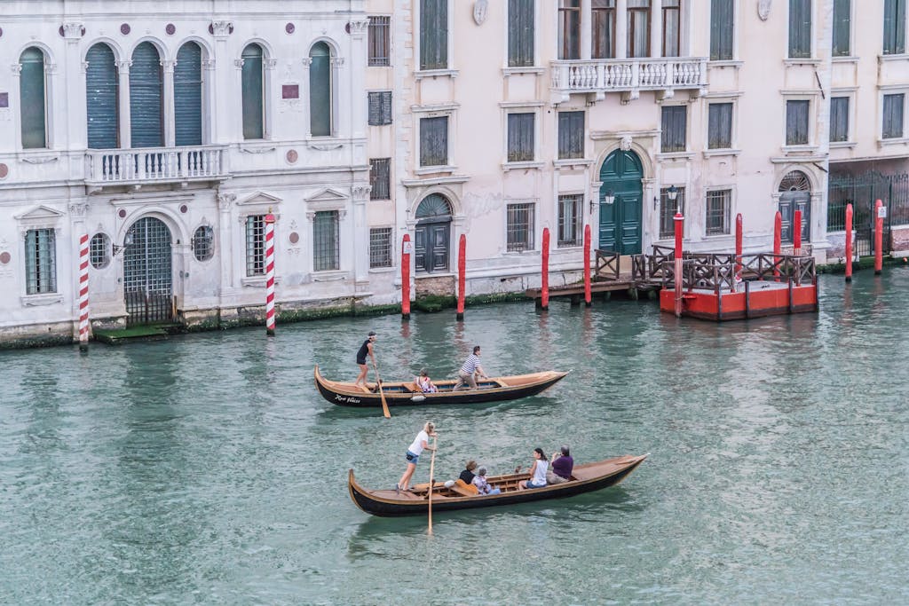 Gondolas gliding on Venice's Grand Canal, showcasing historic architecture and vibrant culture.