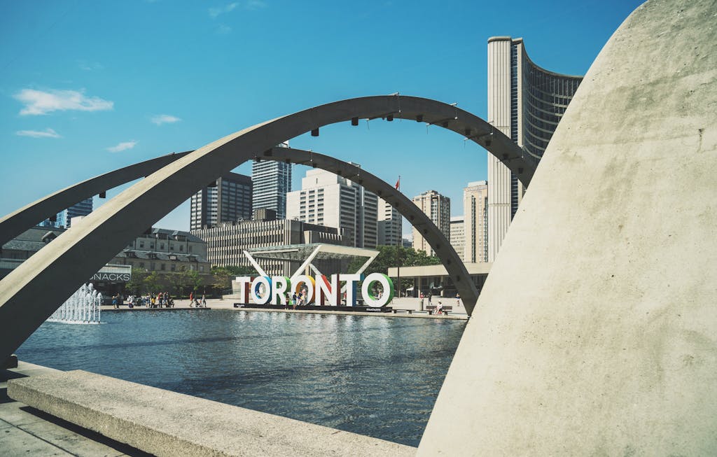 Modern architecture and skyline at Nathan Phillips Square, Toronto with iconic sign.