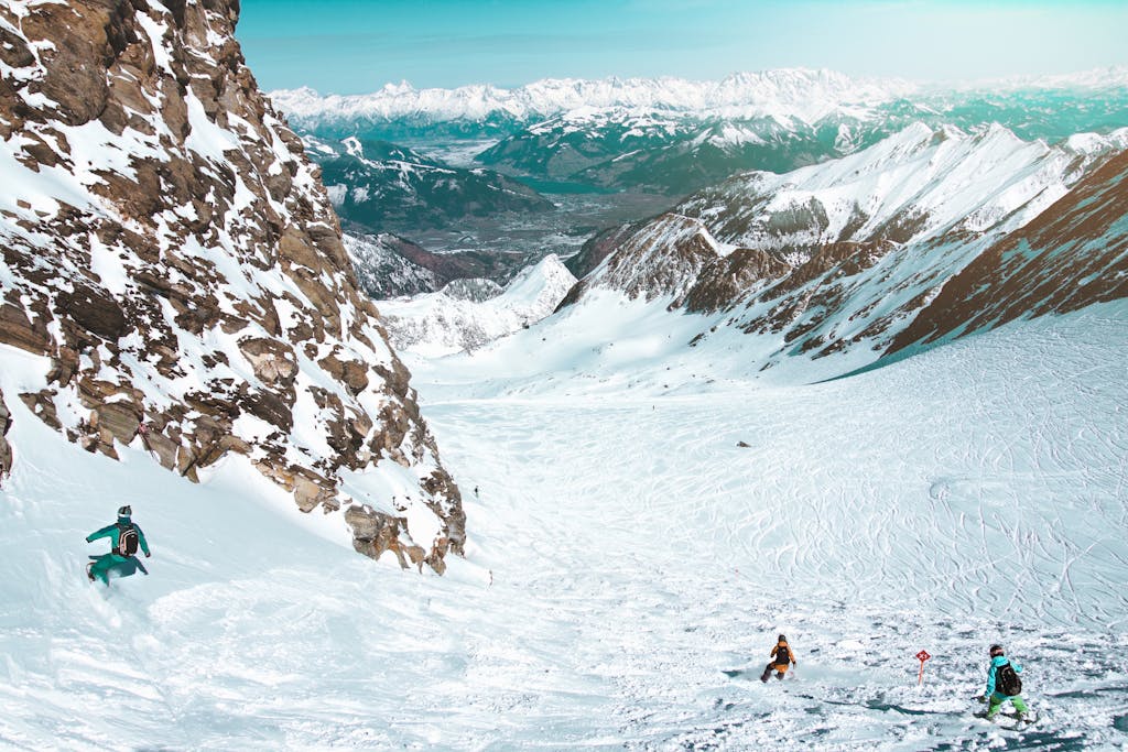 Snowboarders navigating snowy slopes of Zell am See, Austria, showcasing a breathtaking winter landscape.