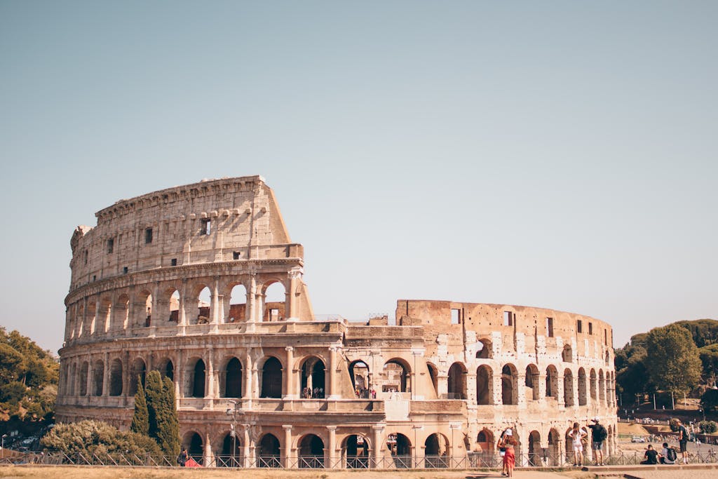 Stunning view of the ancient Colosseum in Rome, Italy under a clear blue sky.