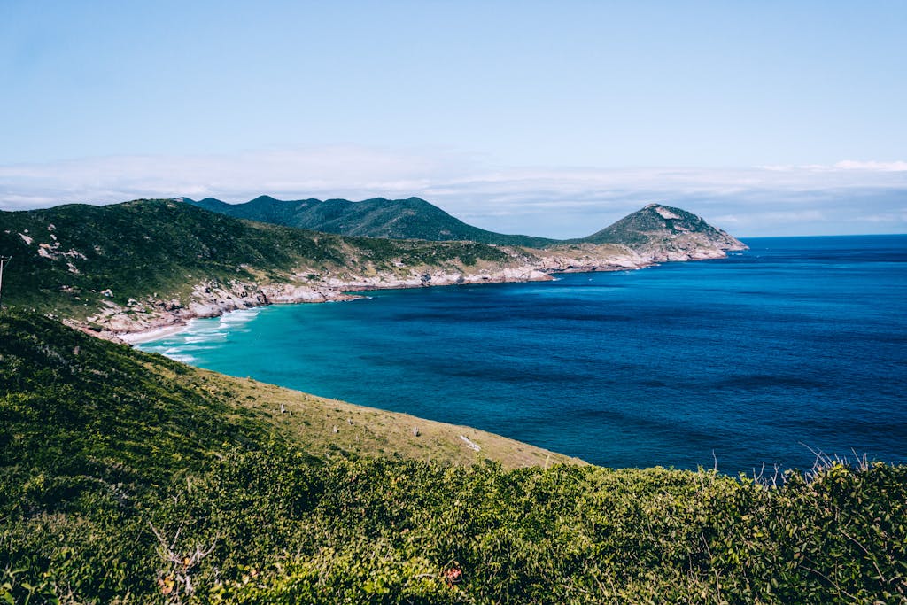 Stunning view of the Arraial do Cabo coastline with turquoise waters and lush hills.