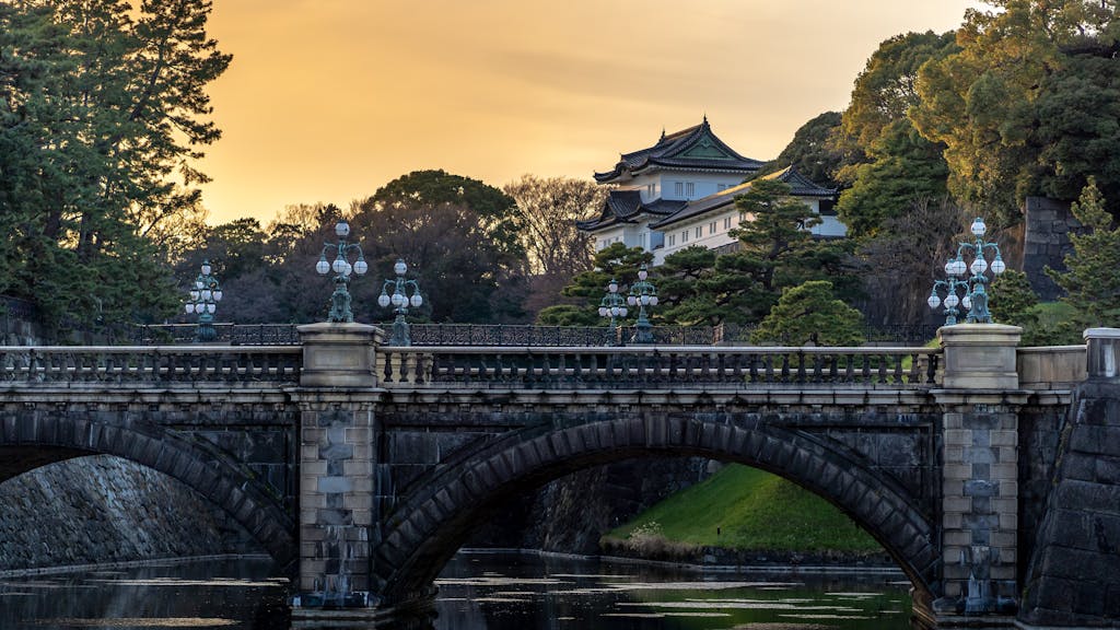 Stunning view of Tokyo's Imperial Palace and famous bridge at sunset.