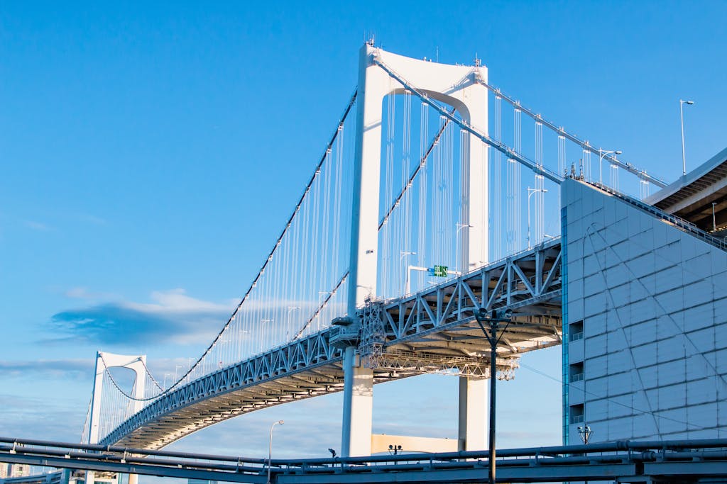 Stunning view of Tokyo's Rainbow Bridge under clear blue skies.